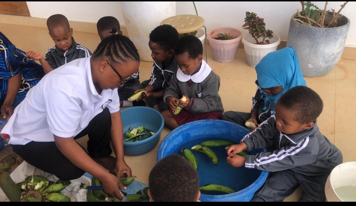 Children peeling bananas during cooking class